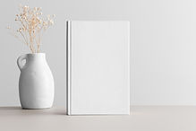 White book mockup with gypsophila in a vase on a beige table..jpg