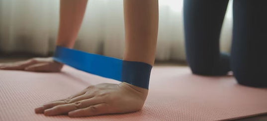 A close-up shot of feet and legs resting on a mat with props, symbolizing the supportive and gentle nature of Restorative Yog