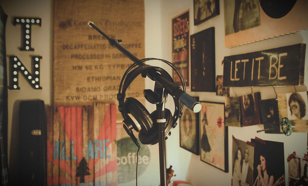 Recording microphone and headphones in a creative music studio, representing consistent practice, music production and artistic development.
