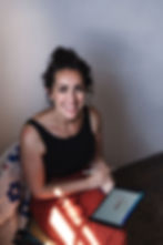 Abbie Downey from Feather&Fossil interior design working on an ipad to create a bespoke client design.