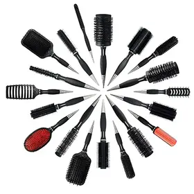 A collection of different hairbrushes laid out in a salon setting, showing options for curly, straight, thick, and afro hair types.