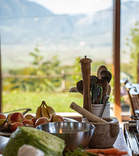 Tools and fruits on the counter and view from the kitchen