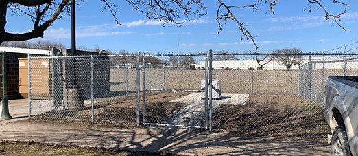 Commercial chain link gate securing life-saving equipment, providing controlled access to essential emergency resources.