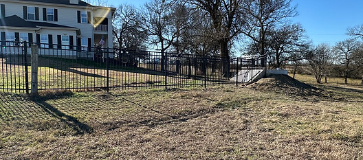 5' Three-Rail Ornamental Fence Enclosing Storm Shelter – A sleek wrought iron fence in Sherman, TX provides a secure enclosure around a storm shelter, ensuring both storm safety and a designated space for dogs to roam freely.