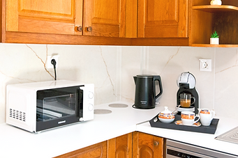 Dedicated morning coffee station with an espresso machine and tea kettle.