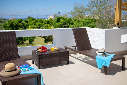View from the Villa Komorebi lounge deck overlooking lush olive groves and the Libyan Sea horizon, known as the "Green Ocean."