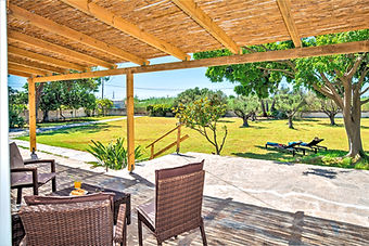 Shaded outdoor lounge patio looking out over the private, completely enclosed garden in Ierapetra.