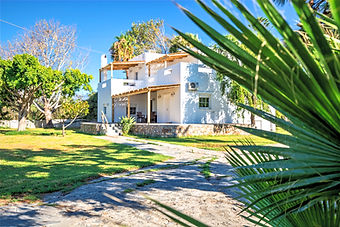 Expansive 2,500sqm private green lawn and mature trees at the family-friendly luxury estate in South Crete.