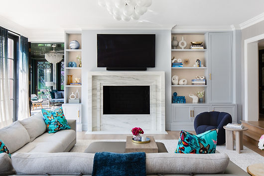 Laurel Hollow family room interior designer design with plush seating, custom millwork, and custom marble carved fireplace