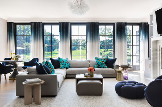 Roslyn interior designer family room with plush sectional, layered textures, ombre window sheers, and custom marble fireplace