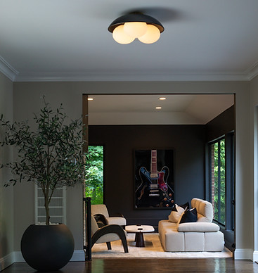 mid-century modern living room with black painted walls, neutral furnishings