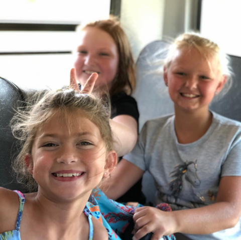Kids laughing on bus at Summer Camp