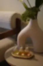 A tranquil corner at Z'Oasis spa in Geneva featuring a modern ceramic vase, fresh greenery, and a set of essential oils for relaxation and wellness.