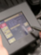Diagnostic tablet running a check on a Ford Transit.