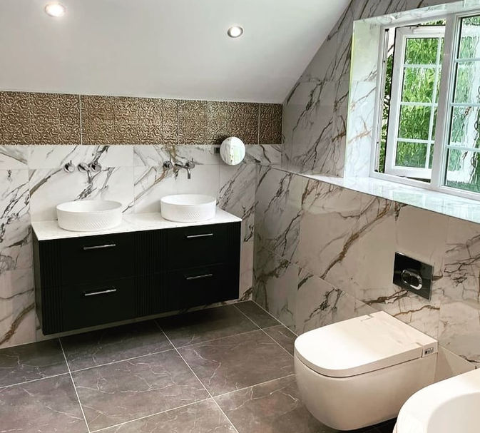 With a whirlpool bath, walk in "wet floor" style shower and a Vira V Care smart bidet toilet - we fitted these large marble tiles and dual vanity unit. There is a large recessed drench style shower and plenty of feature lighting to really set off this large classic Master Ensuite.