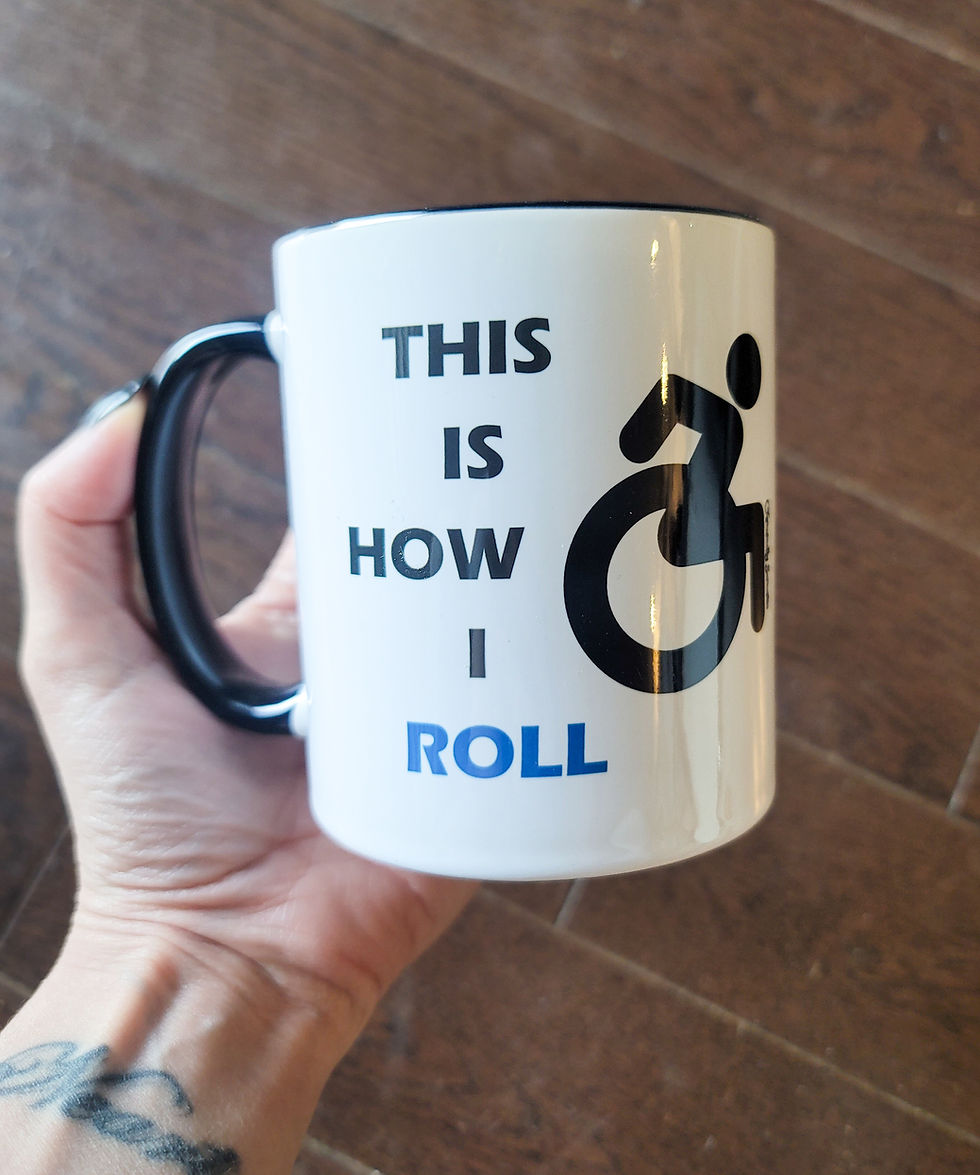 Thumbnail: Black and white "This Is How I Roll" sarcastic wheelchair mug held in a left hand on a dark background