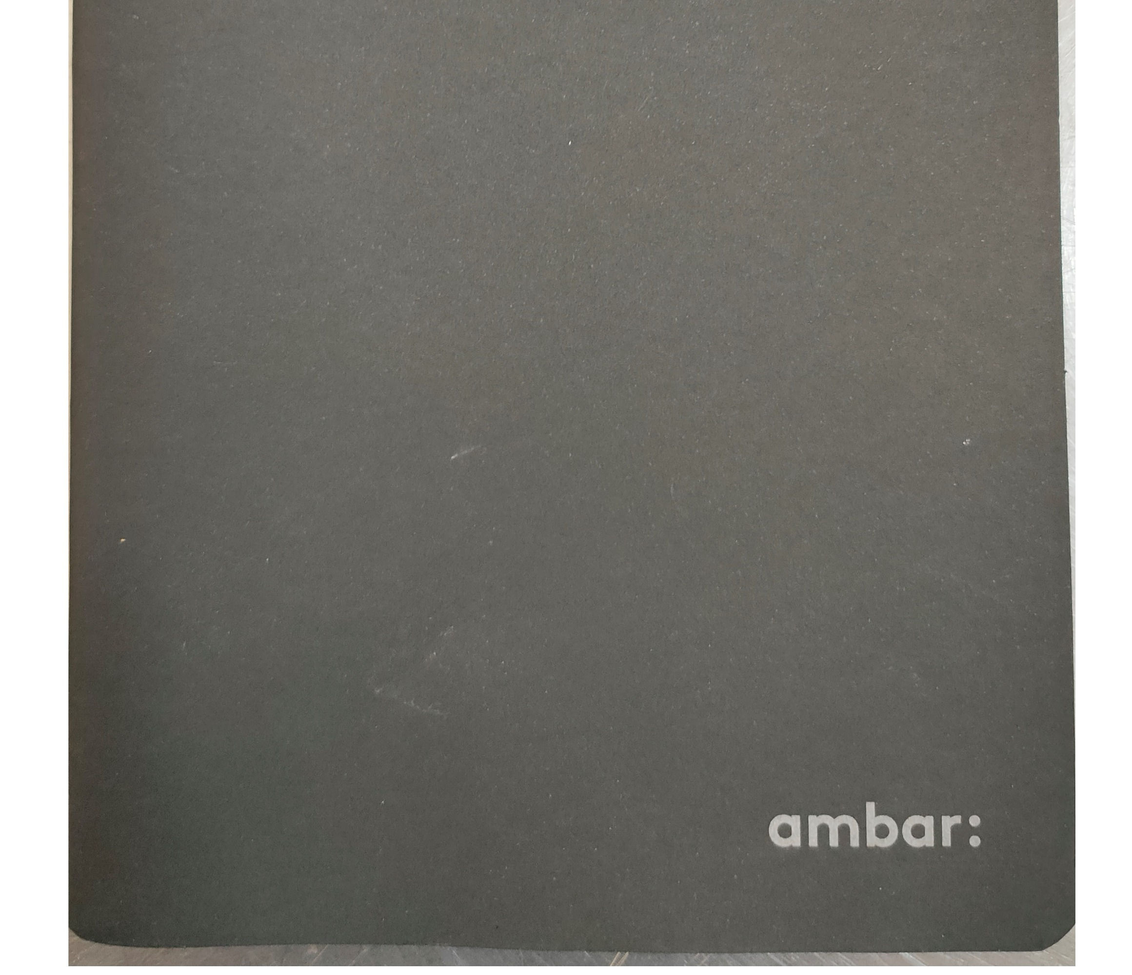 Caderno A5 agrafado quadriculado ambar
