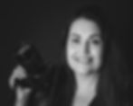 Black and white image of a woman holding a camera