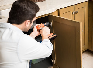 point-view-young-handyman-using-power-drill-fix-door-kitchen-cabinet.jpg
