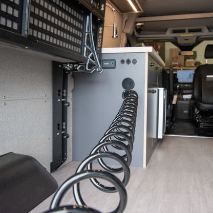 Minimalist outdoor shower with 15ft retractable hose connected to Ford Transit camper van kitchen galley water system