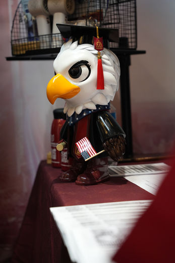 The American University of Science mascot dressed in graduation attire, symbolizing academic excellence and lifelong learning.