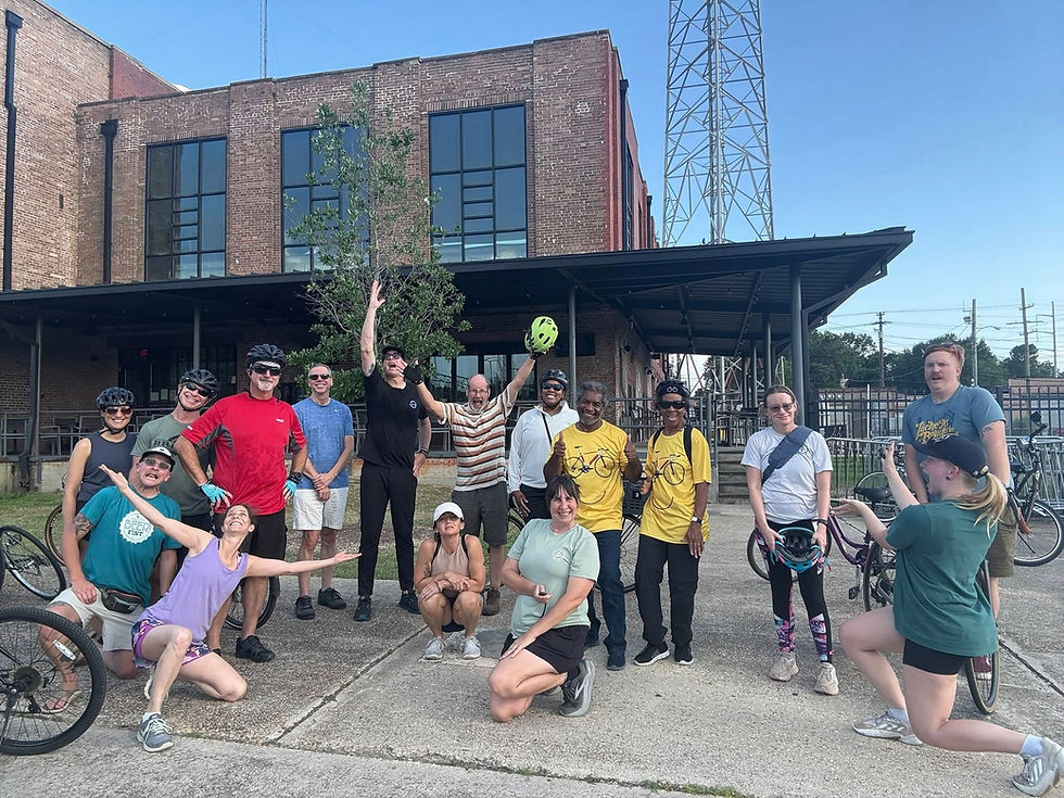 A group picture of the Downtown East Social Ride outside the Electric Depot.