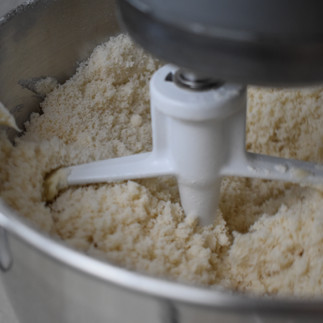 Mixing ingredients for homemade confetti cake with vanilla custard and buttercream