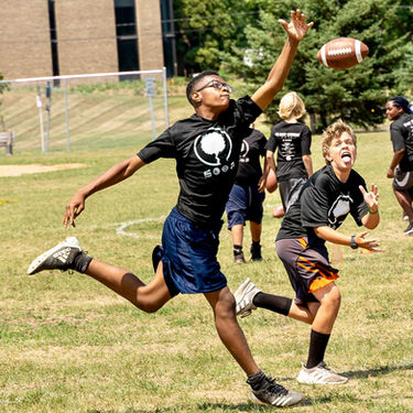 Two boys playing football at the Bay Laurel Fund Football Camp.