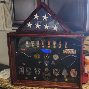 Classic two-tier military shadow box combining triangular flag display case with rectangular medal and patch showcase in rich cherry-stained wood finish. The upper compartment holds properly folded ceremonial flag while lower shadow box displays full military career memorabilia including service medals, unit patches, rank insignia, challenge coins, qualification badges, unit crests, combat patches, and ribbon bars arranged on black felt backing. This traditional design honors complete military service from multiple deployments and assignments with comprehensive display of earned honors. Perfect military retirement gift, funeral flag case, veteran memorial, or family tribute preserving decades of Army service including Special Forces, airborne, and combat unit assignments with distinguished presentation.