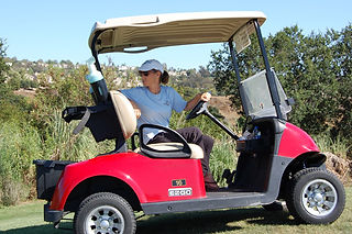 Woman driving red golf cart at Laguna CC