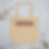 Beige tote bag with "HUMAN" in red and black lettering