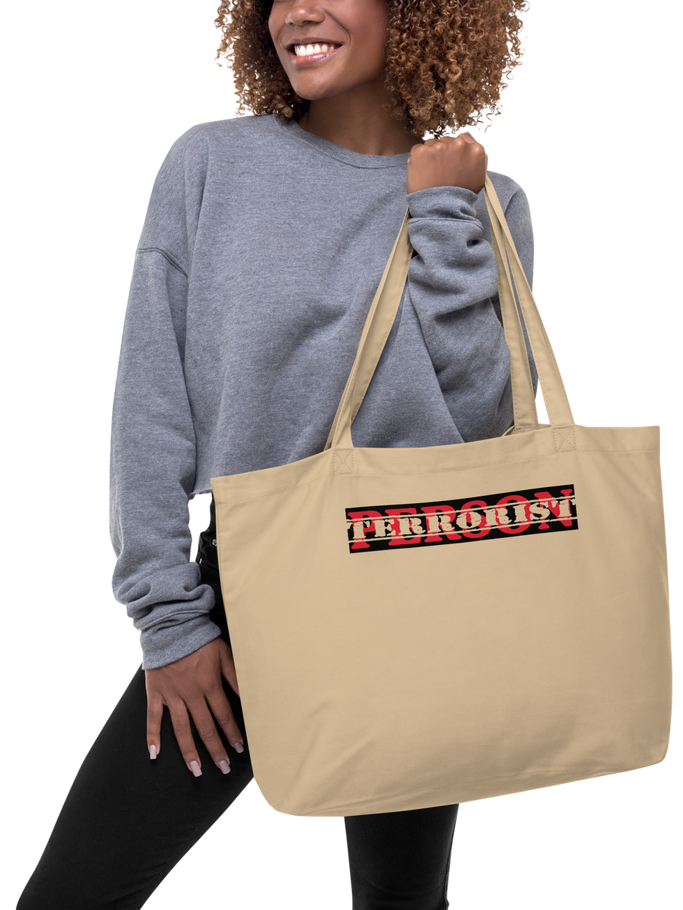 Woman holding beige tote bag with "PERSON" logo