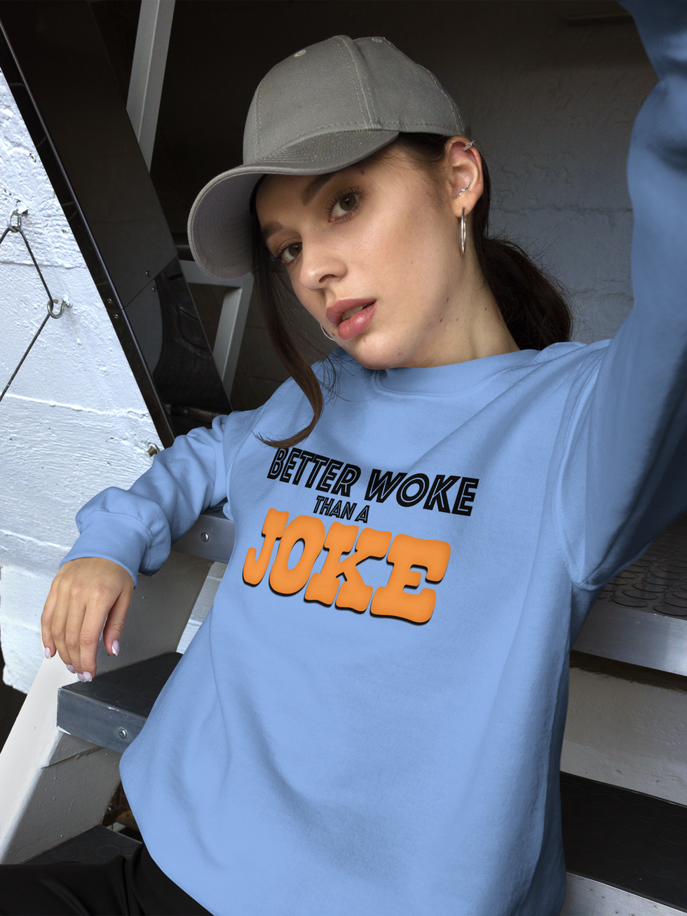 Woman in light blue "Better Woke Than a Joke" sweatshirt