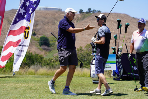Golfers conversing at 3rd Annual Canyon Club Golf Classic