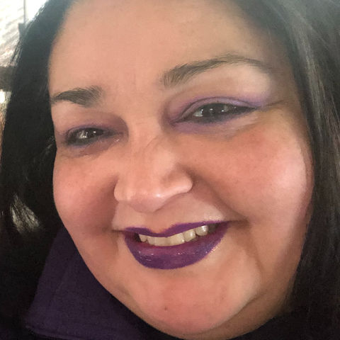 Smiling woman with purple lipstick
