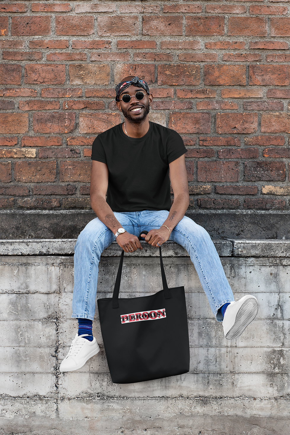 Man smiling, black tote bag with "PERSON" logo