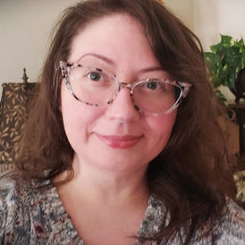 Friendly headshot of woman wearing glasses