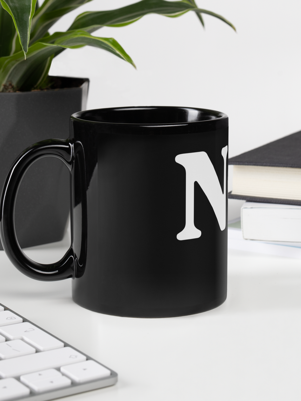 Black mug with N, on a desk