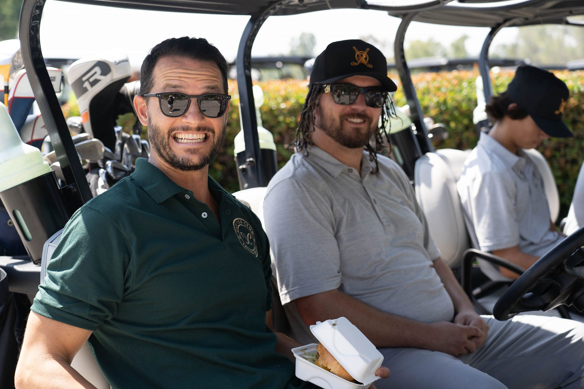 Two men smiling in golf cart at Laguna CC
