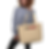 Woman holding beige tote bag with "TER/RESIST" text