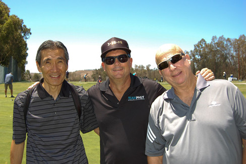 Three men smiling at golf course