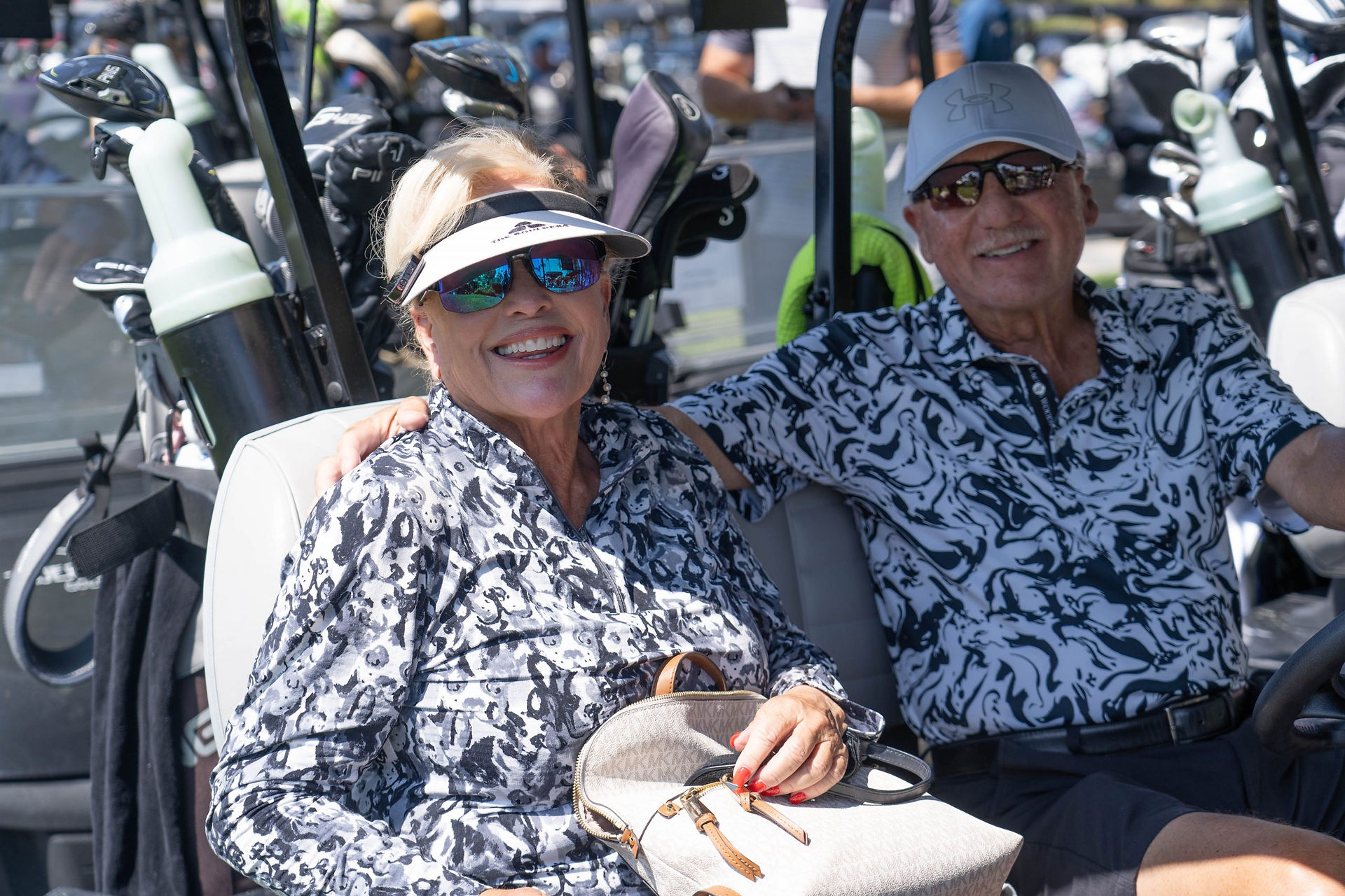 Smiling couple in golf cart at Laguna CC