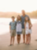 Family beach portrait: Becca Hintergardt and family smiling at sunset