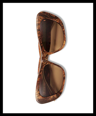 Oversized upswept sunglasses with bold curves and a sophisticated statement silhouette designed to stand out.