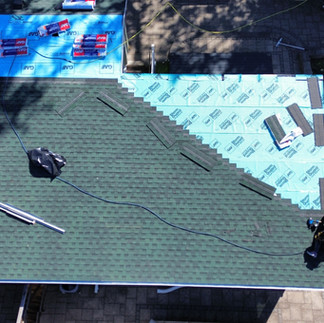 A Mississauga home mid-roof replacement with GAF synthetic underlayment installed and roofing materials staged on the surface, showing the early stages of Rain Safe Roofing’s step-by-step installation process.