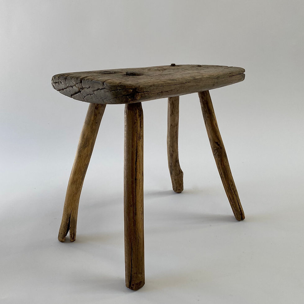 Thumbnail: A primitive wooden stool with four splayed legs