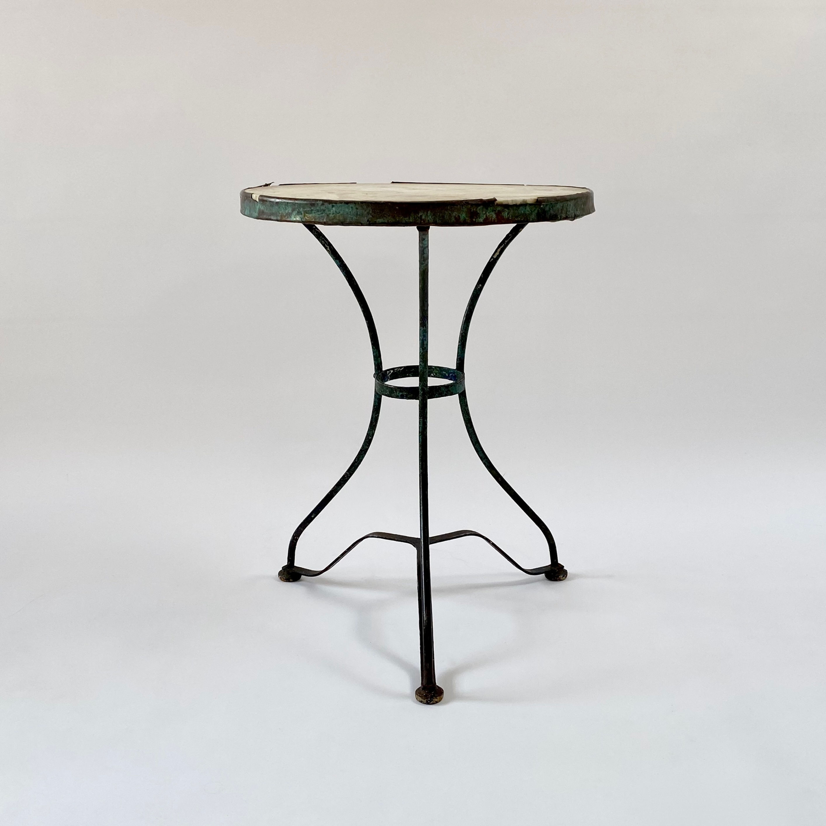 French marble top bistro table a wonderful patina of old green and blue paint layers.
