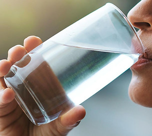 A woman drinking a glass of water