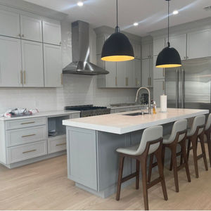 Modern kitchen with island and pendant lights.