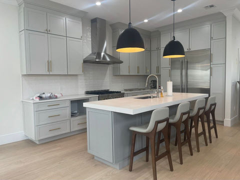 Modern kitchen with island and pendant lights.